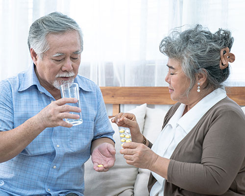 elderly asian couple with medication