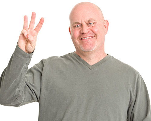 stock image of man holding up three fingers